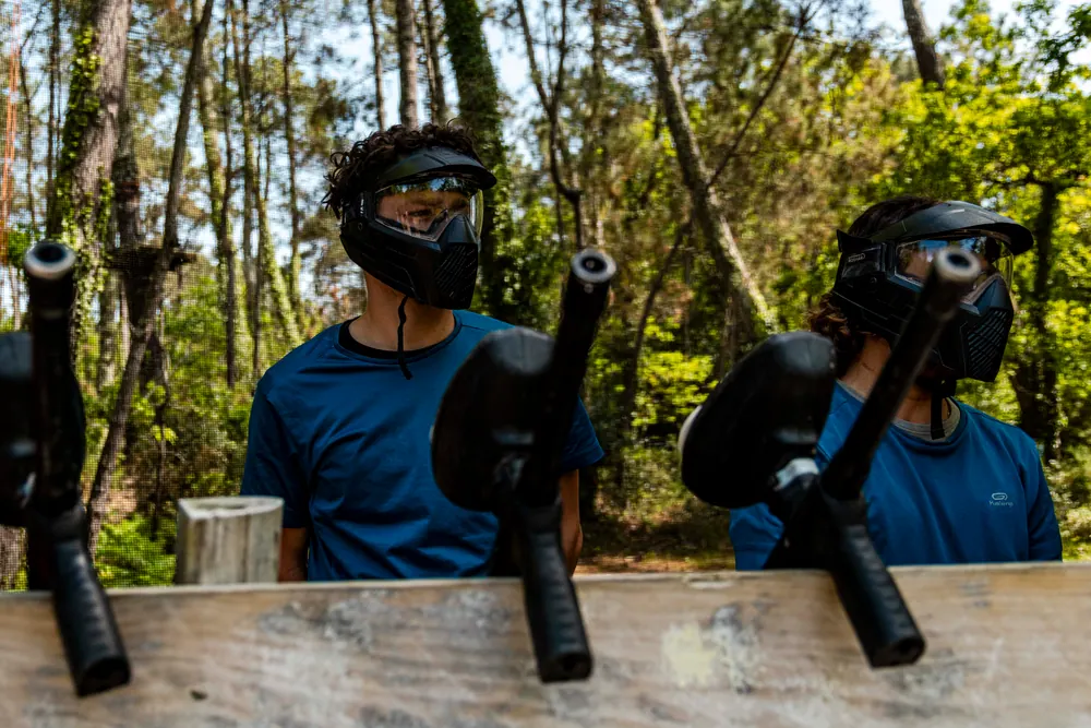 Joueurs équipés de leur masque de paintball, prêts à entrer sur le terrain